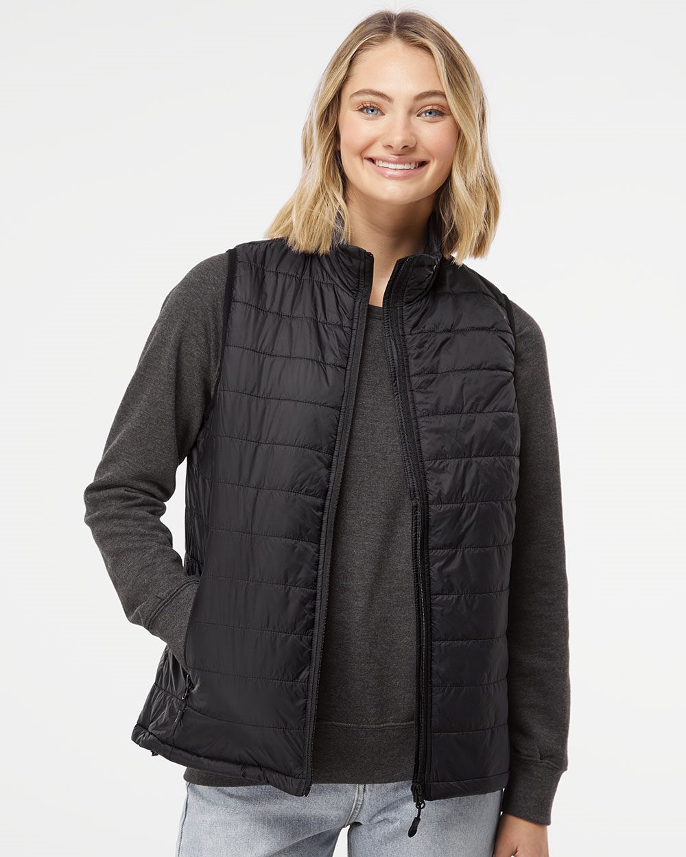 Independent Trading Co.'s Women's Puffer Vest features a wind- and water-resistant nylon exterior with a cozy polyester lining.