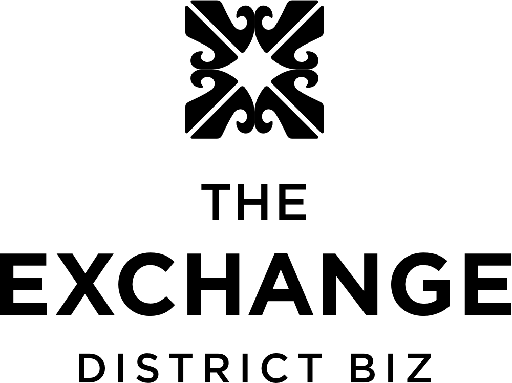 The Exchange District BIZ logo, a symmetrical scrollwork emblem above the name