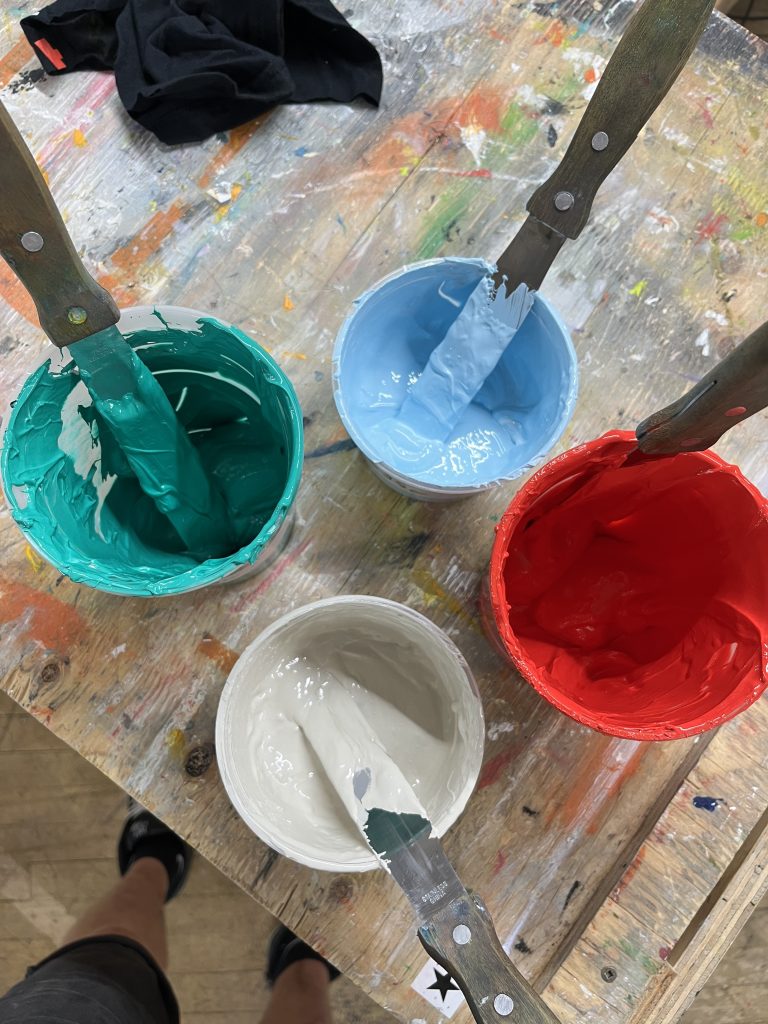 Mixing plastisol ink by hand at Floodway's ink station