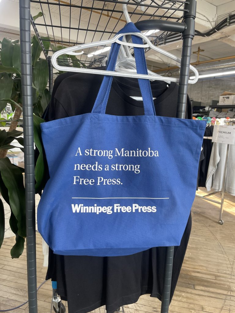 Blue cotton tote printed in white, A strong Manitoba needs a strong Free Press, Winnipeg Free Press